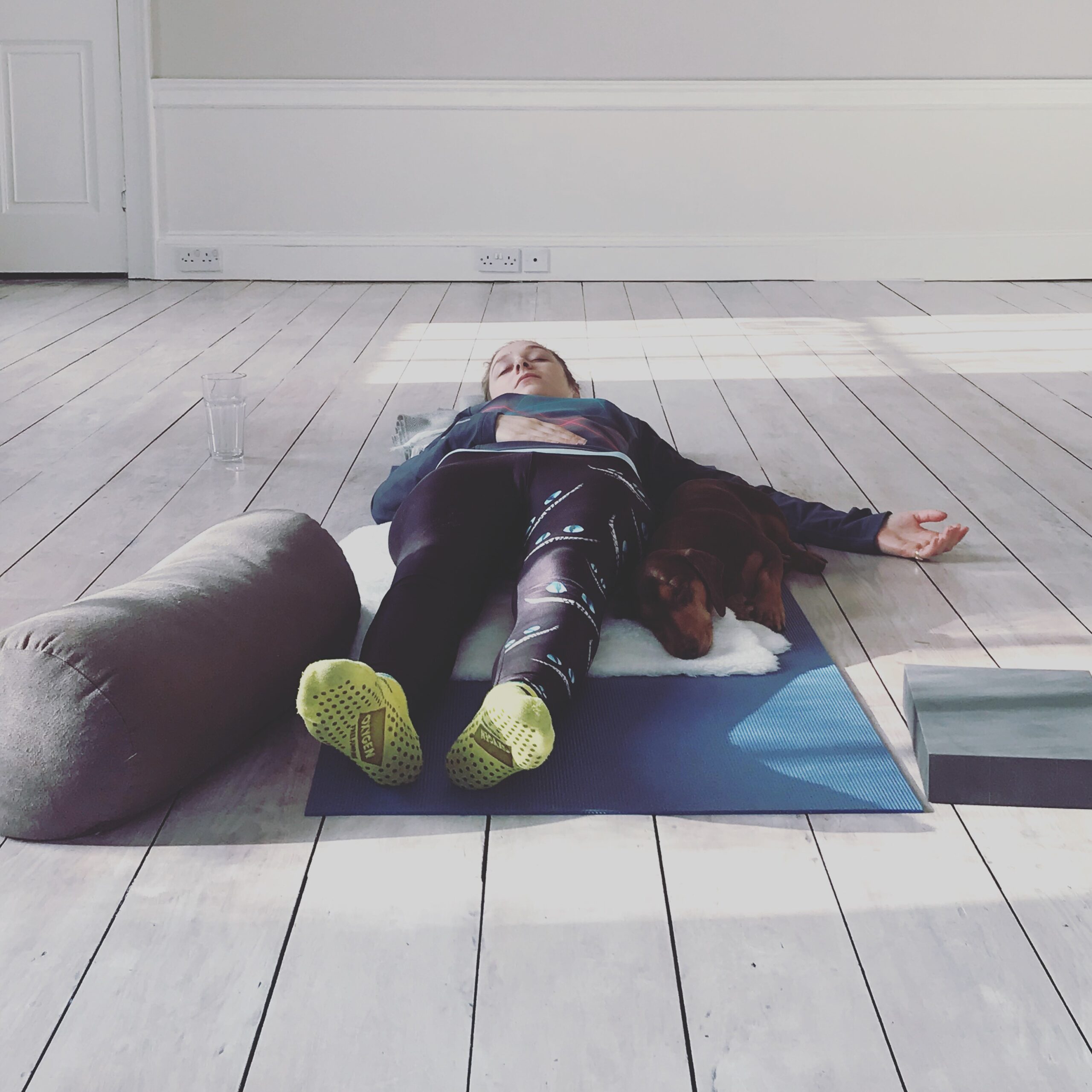 yogaspaceyorkshire studio with one student in savasana